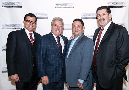 The principal owners of Malatesta Paladino Inc. pose in 2018 at a holiday party. Pictured (from left to right): Corporate Secretary John Novello, Vice President Michael Paladino, Treasurer Patrick Pallentino and President Carmine Malatesta.